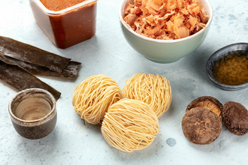 Ramen ingredients. Dried sea vegetable kelp, soba noodles, dashi, tuna flakes, shiitake mushrooms, sake, red miso paste, mirin