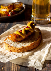 Bread with grilled sausage and mustard. German cuisine.