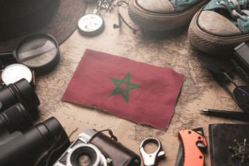 Morocco Flag Between Traveler's Accessories on Old Vintage Map. Tourist Destination Concept.