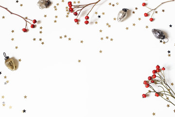 Christmas decorative frame, web banner. Red rose hips, vintage Christmas ornaments and golden...
