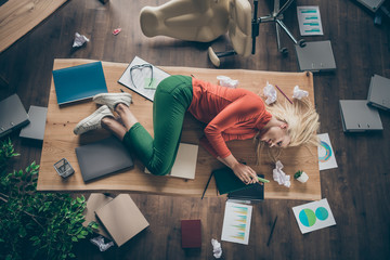 High angle above view photo of corporate messy atmosphere unorganized blond business lady lying...