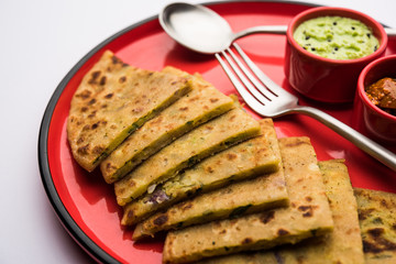 Aloo Paratha / Indian Potato stuffed Flatbread with butter on top. Served with fresh sweet Lassi, chutney and pickle . selective focus