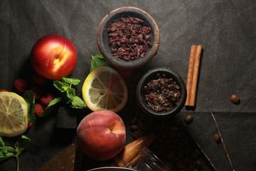 bowl with tobacco for hookah. fruits on a black background. smoking hooka