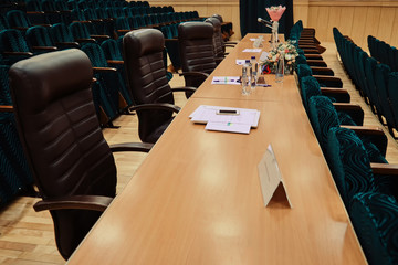 Blank space for the jury of the contest. Long jury table. Places for judges with bouquets of...