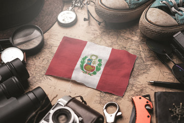 Peru Flag Between Traveler's Accessories on Old Vintage Map. Tourist Destination Concept.