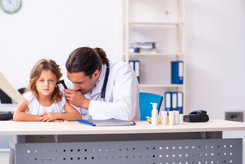 Young doctor pediatrician with small girl