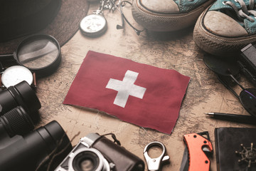 Switzerland Flag Between Traveler's Accessories on Old Vintage Map. Tourist Destination Concept.