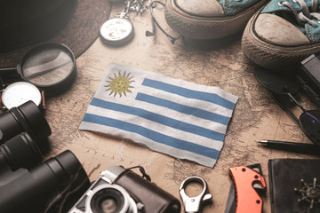 Uruguay Flag Between Traveler's Accessories on Old Vintage Map. Tourist Destination Concept.