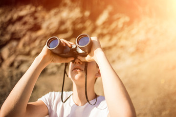 a man looks through binoculars. look through the binoculars. Close-up of a man holding binoculars...