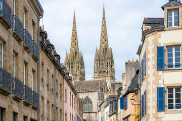 Fototapeta na wymiar Quimper in Brittany, the Saint-Corentin cathedral in a beautiful medieval street 
