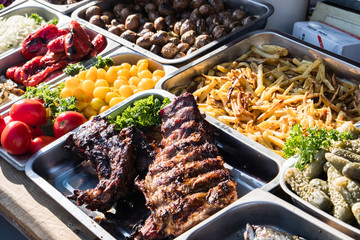 Outdoor Cuisine Culinary Buffet with healthy take away meal - grilled vegetables, fish and meat on...