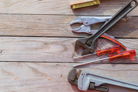 tools arranged on a woodent. On the left side of tools is a space inserting text.