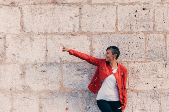 Young Woman Short Black Hair Red Jacket Stone Wall