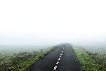 road to nowhere. Road in fog.  Fog in autumn.  Empty aces in haze.