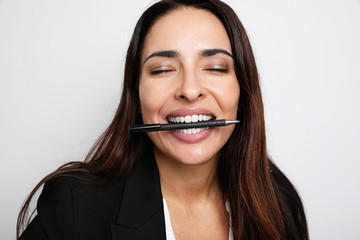 Office secretary young lady posing and making funny face on the white wall. Co-working.