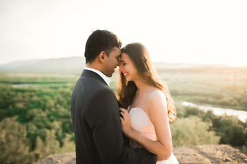 Fototapeta premium Romantic wedding moment, couple of newlyweds smiling portrait, bride and groom hugging