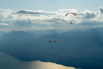 Paragliders flying in mount Baldo, lake Garda, Italy