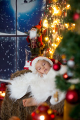 Fototapeta na wymiar Beautiful toddler child, baby boy, sleeping on Christmas eve at home