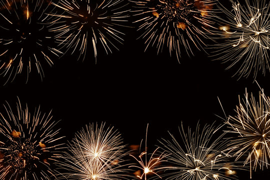 Golden fireworks background with copyspace, new year and holiday night party background