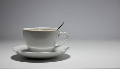 Mug with tea on a white background. Side view.