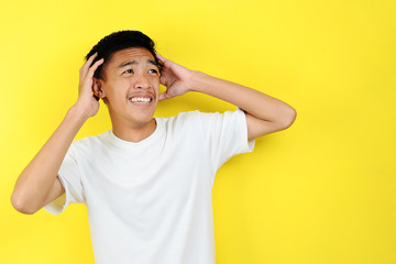 Portrait of young Asian teenager unhappy scared man