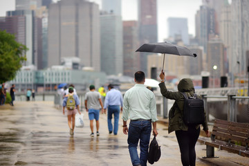 Diverse people on a rainy day in New York city near Brooklyn bridge