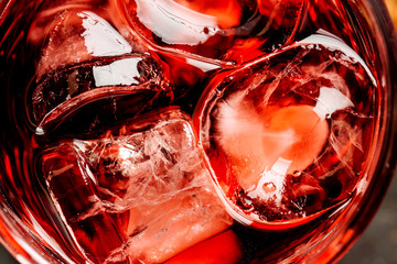 ice cubes close-up in a glass with a drink. view from above. background