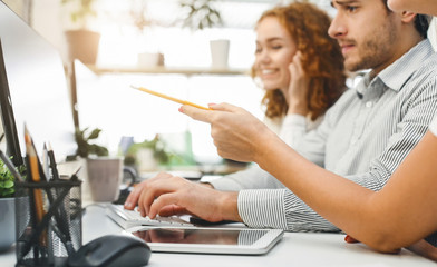 Financial team discussing statistics on computer screen