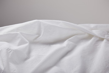 crumpled white cloth isolated on grey with copy space