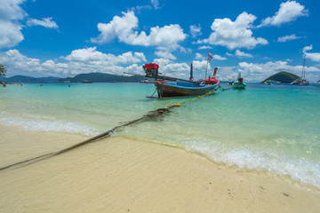 Fototapeta na wymiar Boats off the coast of Phuket, clear water and white sand