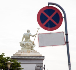 An abstract image with a statue of Neptune triangulating a stop sign 