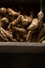 Fresh autumn roots in wooden crate, healthy food
