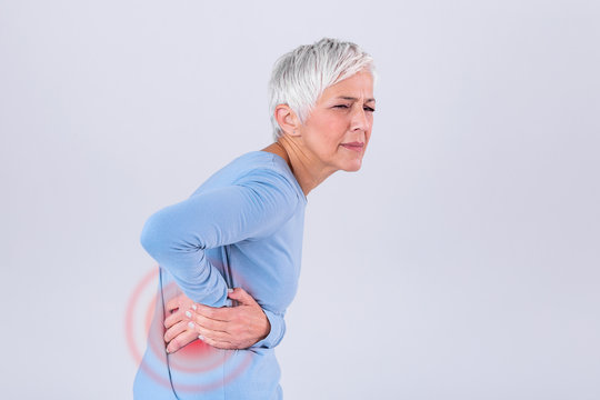 Elderly woman with gray hair touching her aching hip. Upset mature old woman touching back feel hurt osteoarthritis kidney spine ache sore muscles, sad senior lady suffer from lower lumbar pain