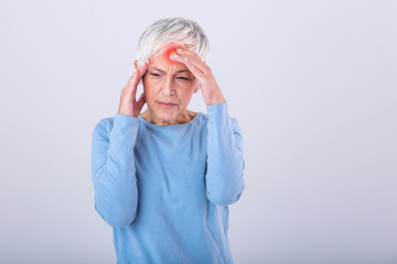 Fototapeta Mature woman holding her head with her hands while having a headache and feeling unwell. Senior woman with headache, pain face expression. Elderly woman having head pain migraine obraz