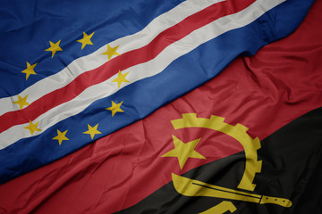 waving colorful flag of angola and national flag of cape verde.