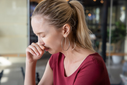 caucasian woman suffering from runny nose; concept of health care, body care, sickness, cold, flu, allergy, fine dust, dusty air, polluted air; pollution