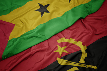 waving colorful flag of angola and national flag of sao tome and principe .