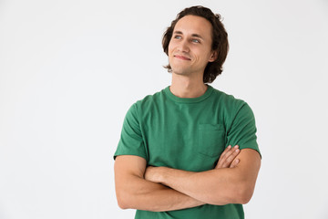 Image of attractive young man looking at copyspace with arms crossed