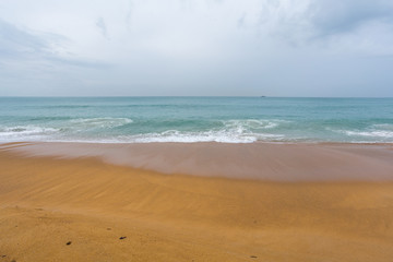 Yellow sand on the shores of the Andaman Sea, Waves in Thailand