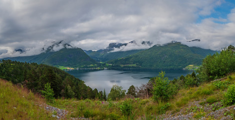 Fototapeta na wymiar Hornindalsvatnet is Norway's and Europe's deepest lake, officially measured to a depth of 514 metres. July 2019