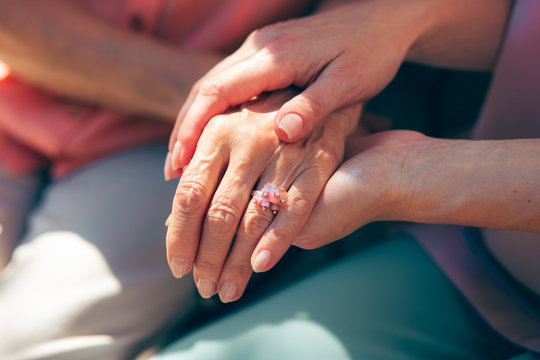 Holding hand of aged mother stock photo