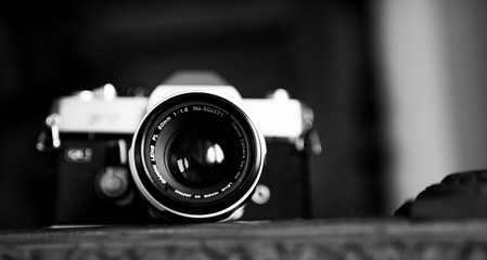 portrait of an vintage film camera from the 1960s in black and white  - Powered by Adobe