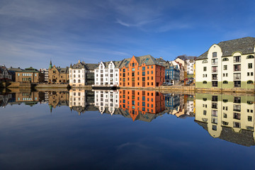 Colorful architecture of Alesund reflected in the water, Norway