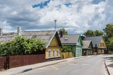 Fototapeta na wymiar Trakai, Lithuania - View of Karaites street with traditional wooden, colored, three window houses