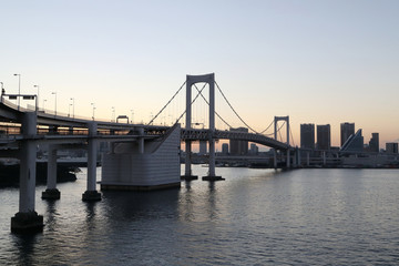 View from Odaiba to Tokyo Bay with Rainbow Bridge at dusk, Tokyo, Japan