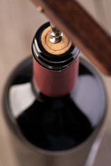 Corkscrew and bottle of wine