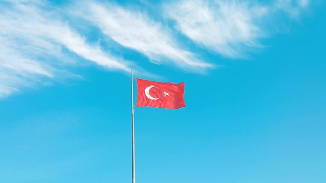 Turkish flag waving on cloudy blue sky
