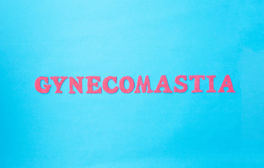 Gynecomastia word in red letters on a blue background. The concept of plastic surgery for adjusting male breasts
