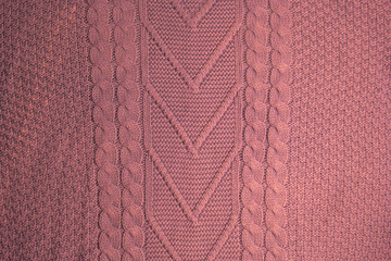 Pattern of colorful knitted sweaters closeup. Handmade merino wool product. Knitting patterns.