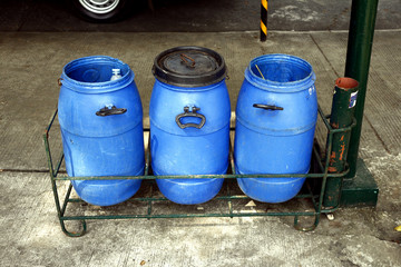 Plastic trash bins on a sidewalk